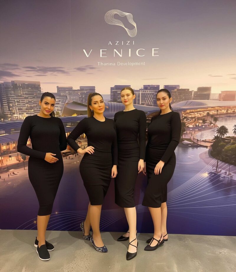 Hype Agency Partner BBP Group Event Staff in Dubai for Azizi Venice Tharina Development Professional event staff managed by BBP Group in Dubai posing in front of a backdrop for Azizi Venice Tharina Development.